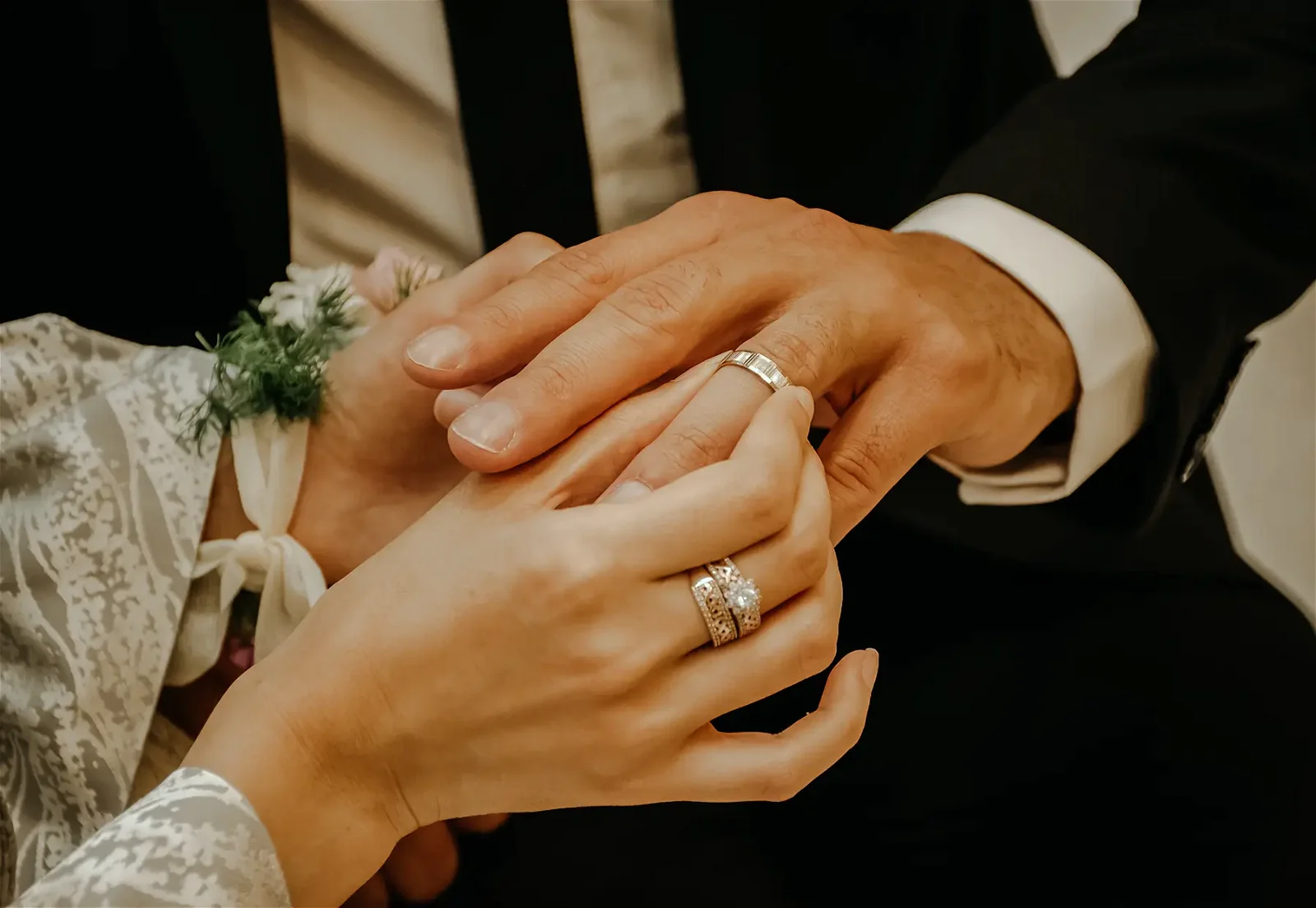 Woman putting a ring on a man's finger