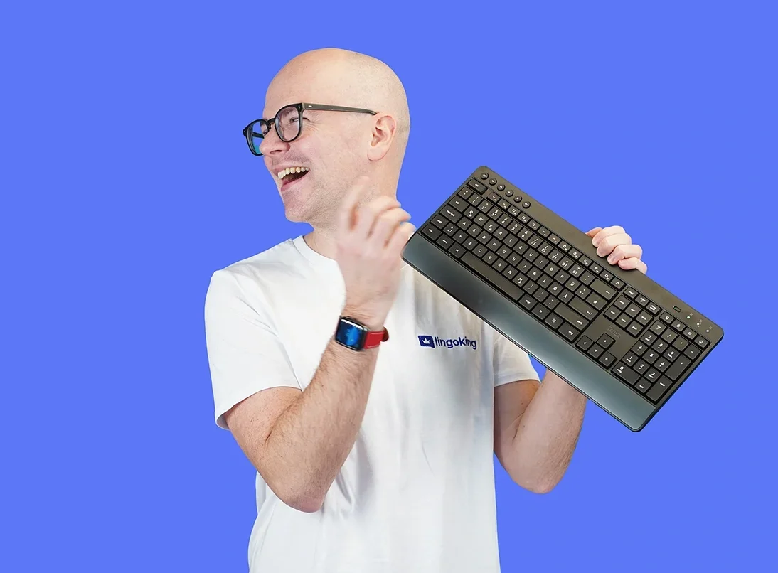 Male employee of lingoking holding a keyboard for laptop