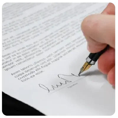 Detailed view of a printed piece of paper that is being signed.