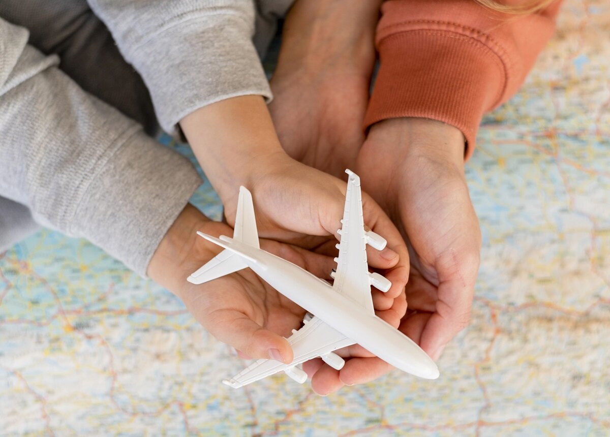 Family holding a model plane