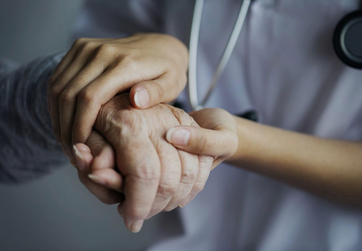 Nurse holding hand of an old person