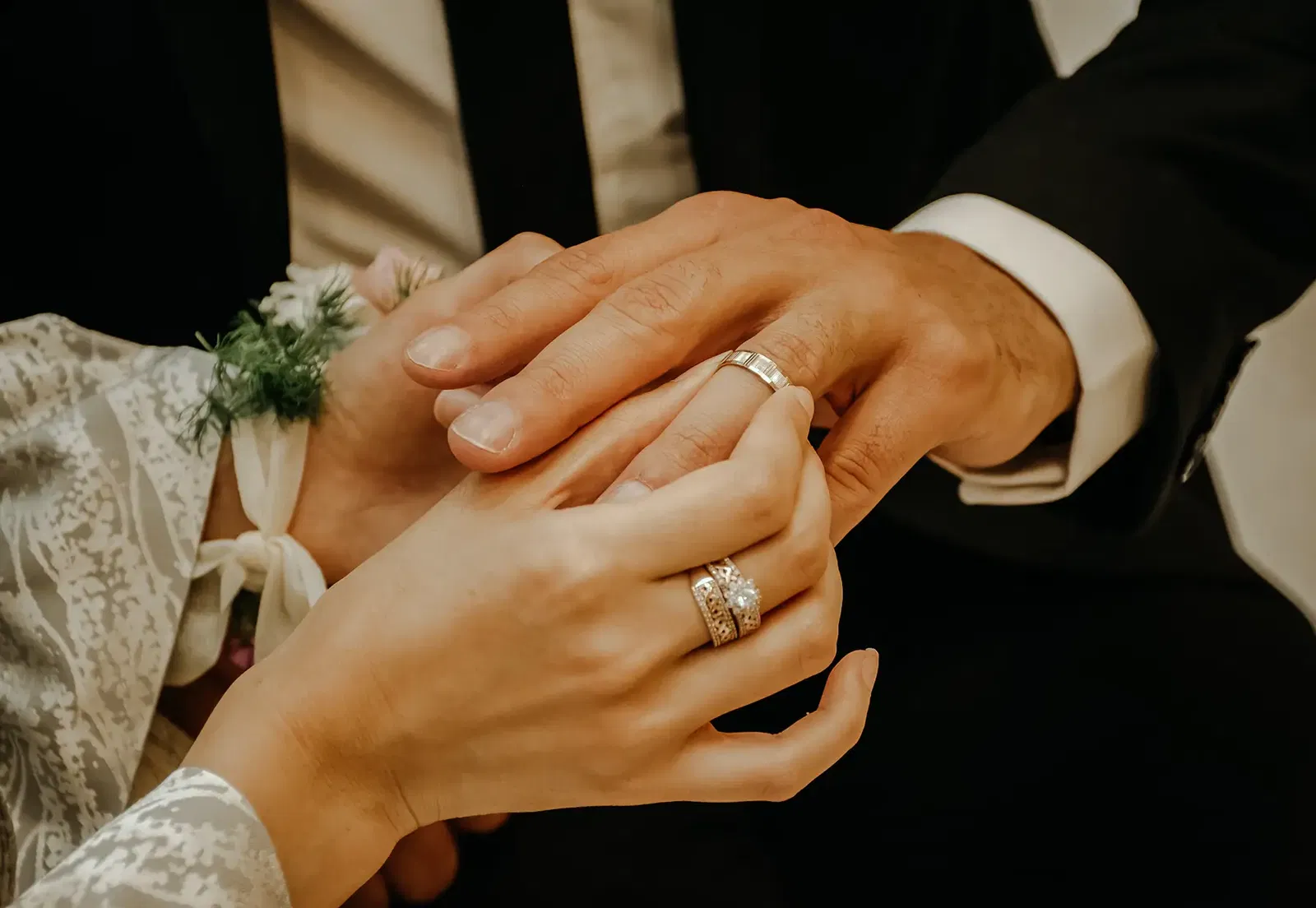 Woman putting ring on man's finger