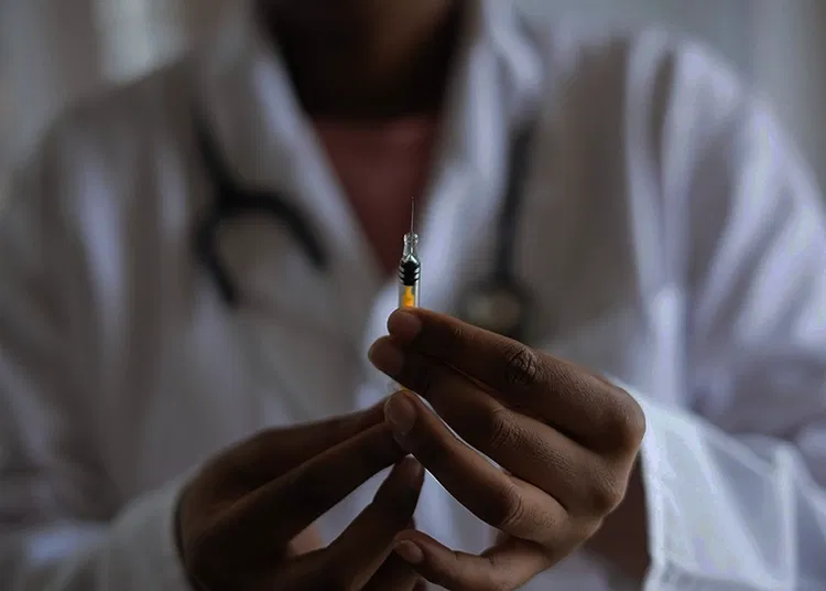 Doctor holding an injection