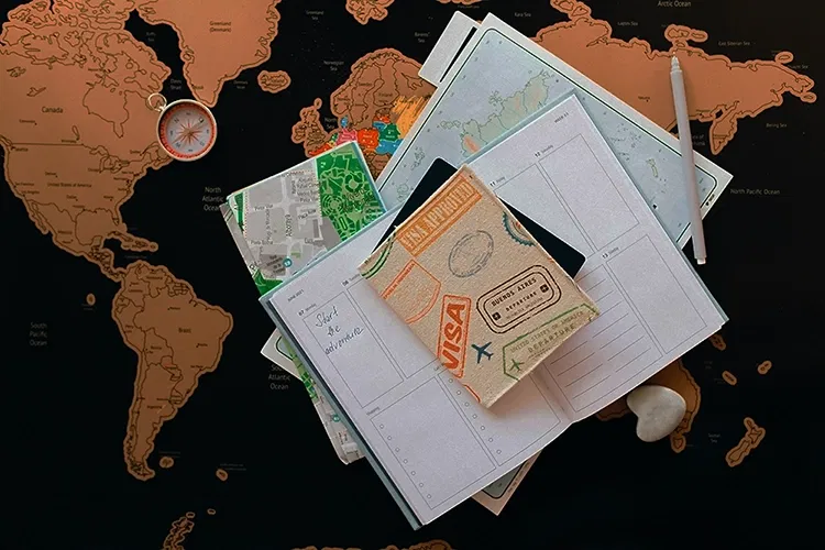 Passport and papers for visa on a map