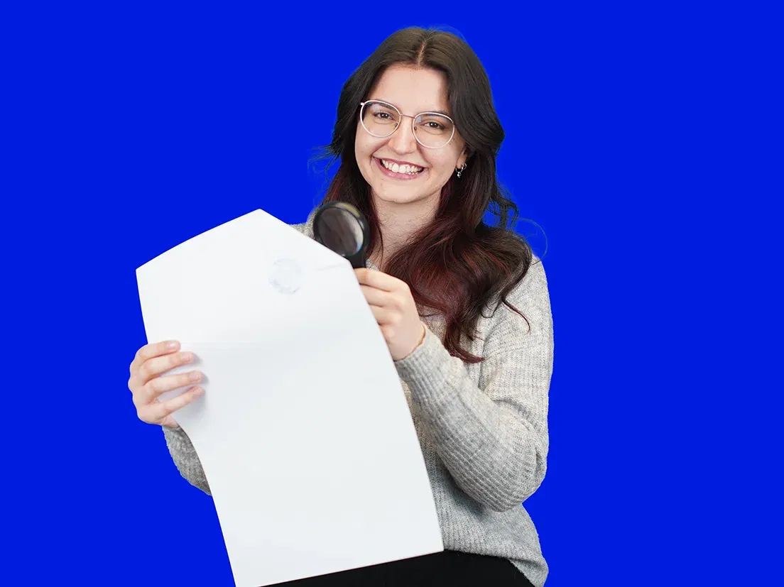 lingoking employee holds certified translation in her Hand with a magnifying glass in the other hand