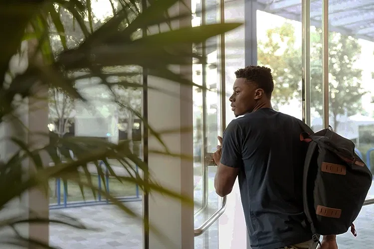 Young man pushing a door