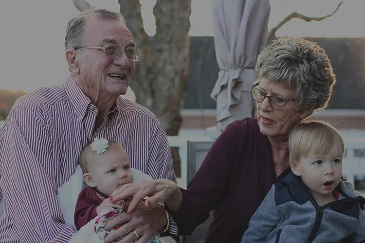 Elderly couple with their grandchildren