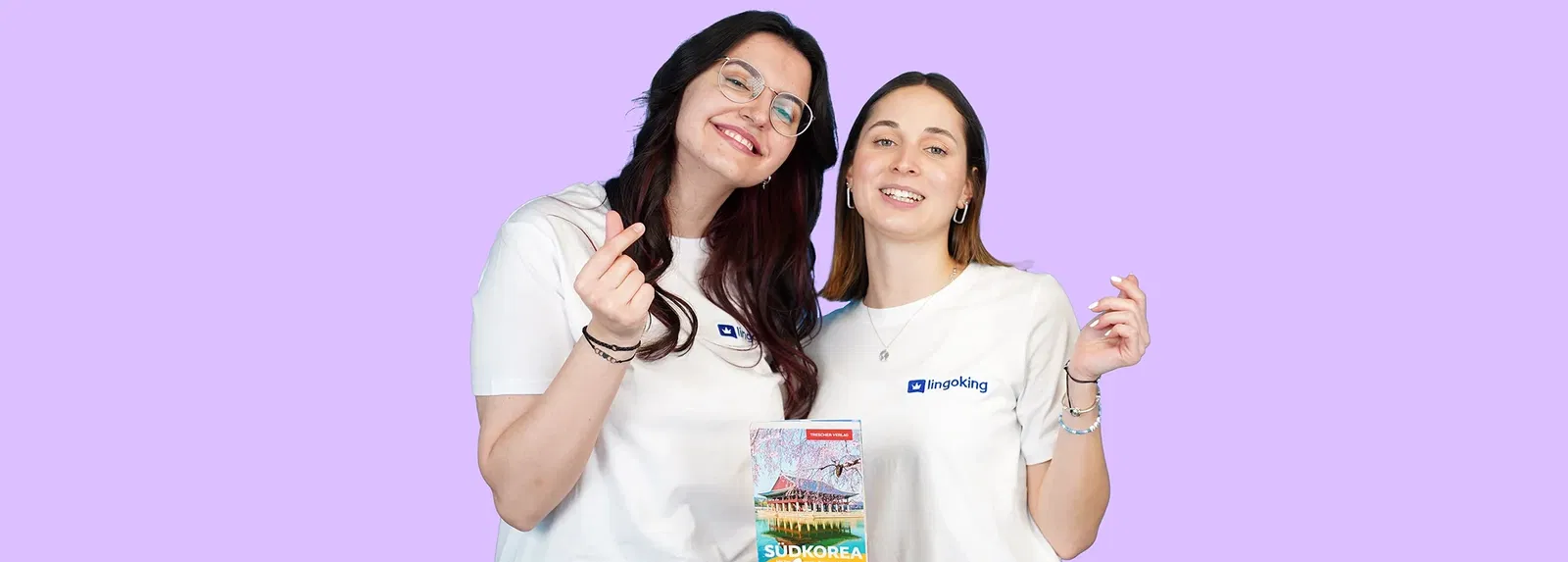 Two lingoking employees standing together symbolizing the korean heart with their fingers