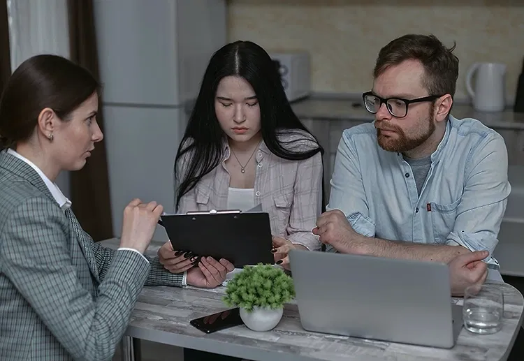 Woman sitting at a table with a couple