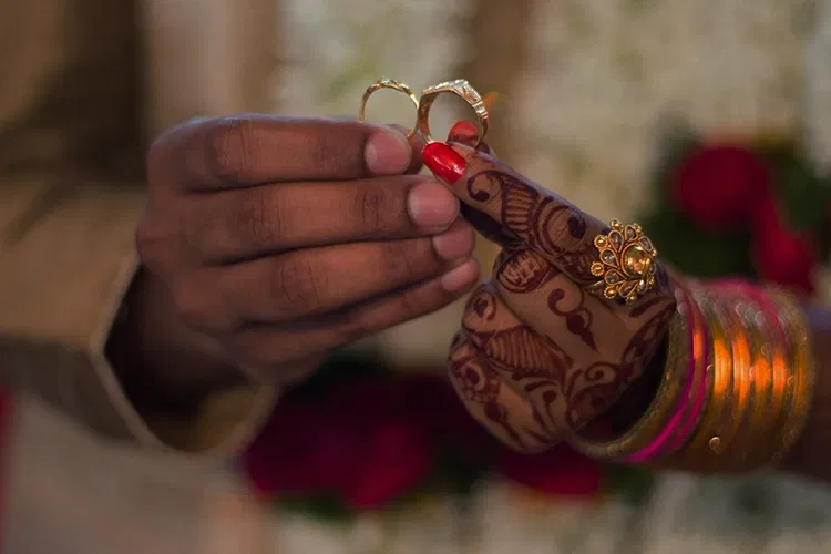 A couple holding two rings