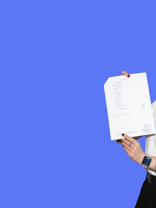 lingoking employee holding a certified translation and holding a magnifying glass