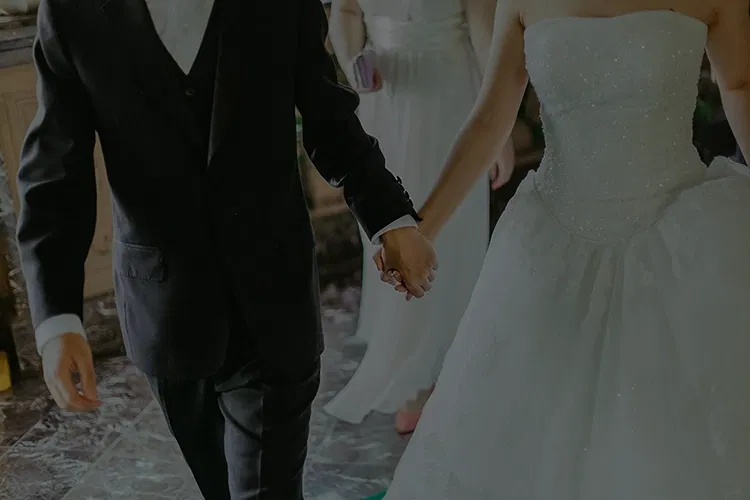 Couple holding hands at their wedding